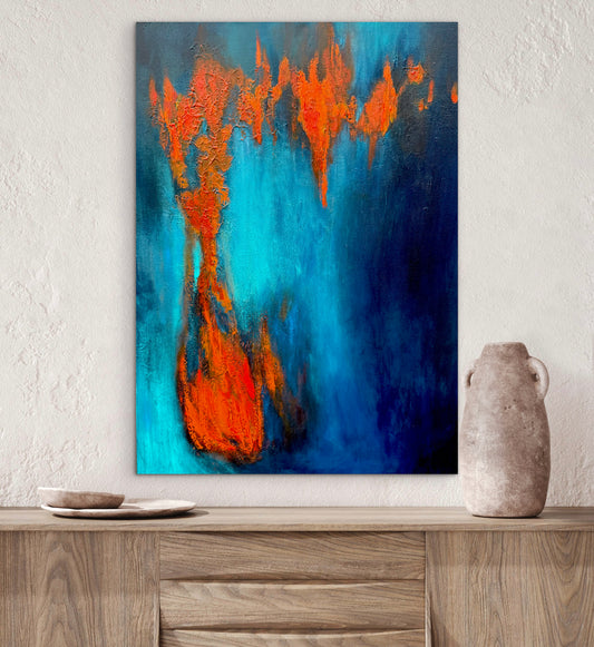Abstract painting with orange and blue hues on a white wall above a wooden shelf.