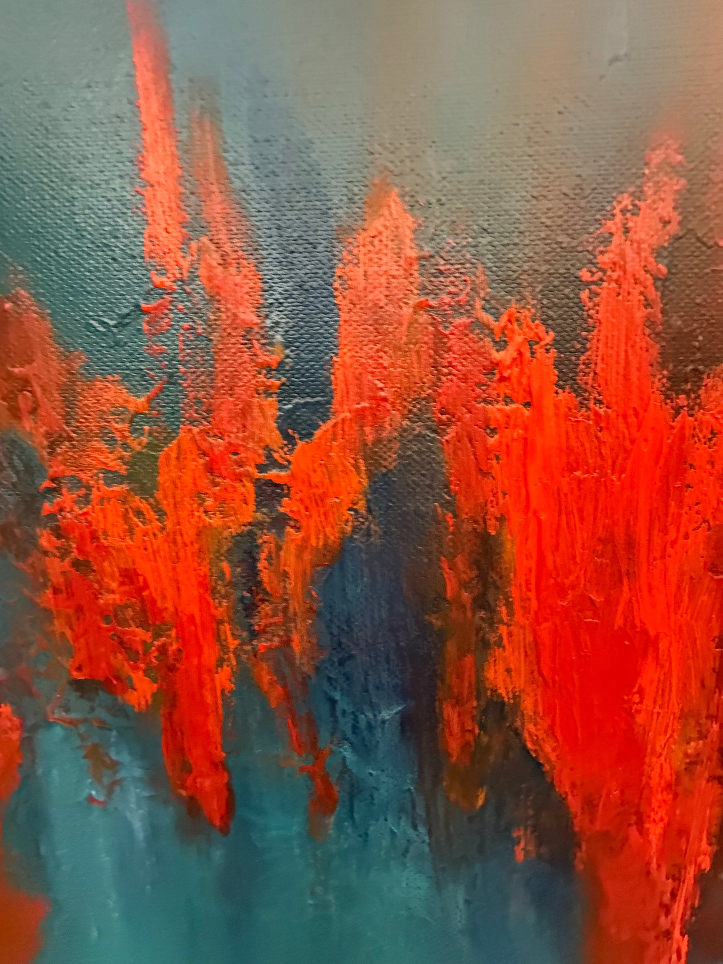 Abstract painting with orange and blue brush strokes on a textured surface