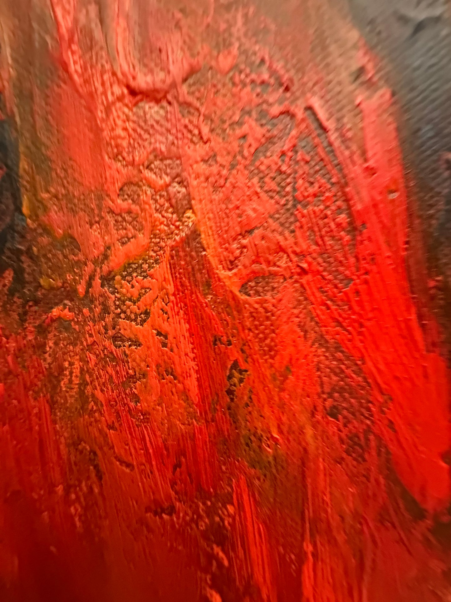 Close-up of textured red surface with brush strokes