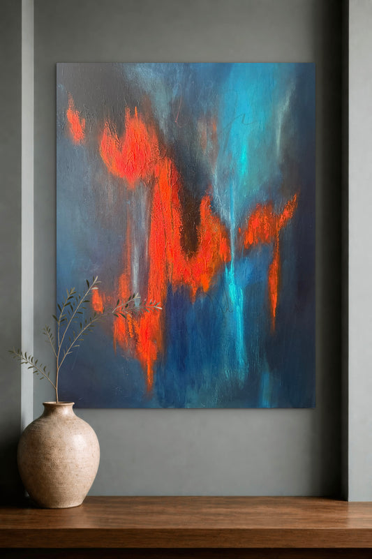 An abstract canvas painting featuring vibrant orange and turquoise blue brushstrokes on a dark gray background, displayed on a gray wall above a wooden mantel with a beige ceramic vase.
