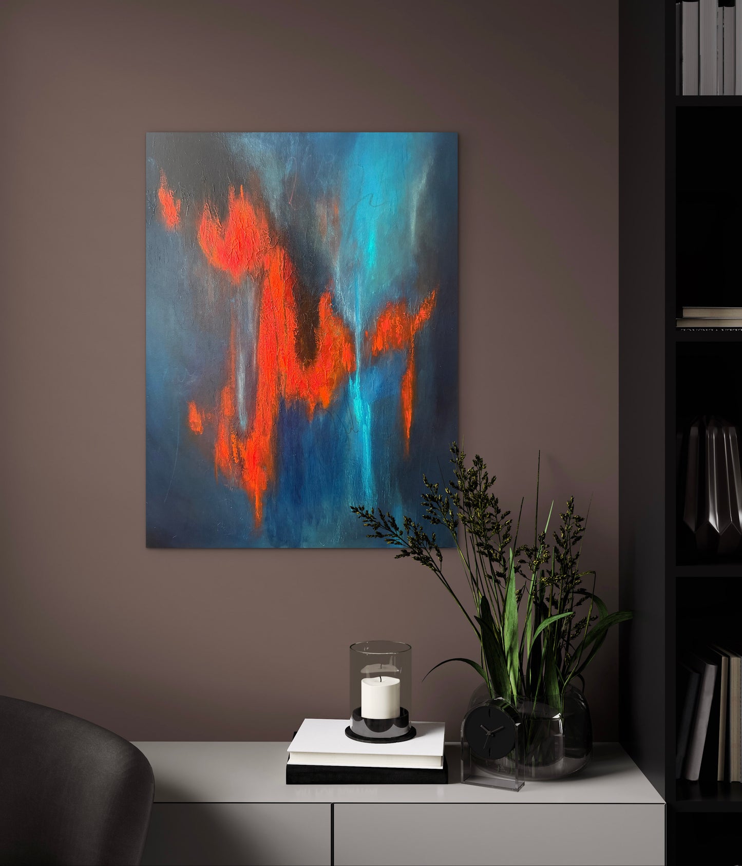 Abstract canvas wall art featuring bold orange and turquoise brushstrokes on a dark blue-gray background, displayed in a modern living room setting above a white console table with a candle and green plants.