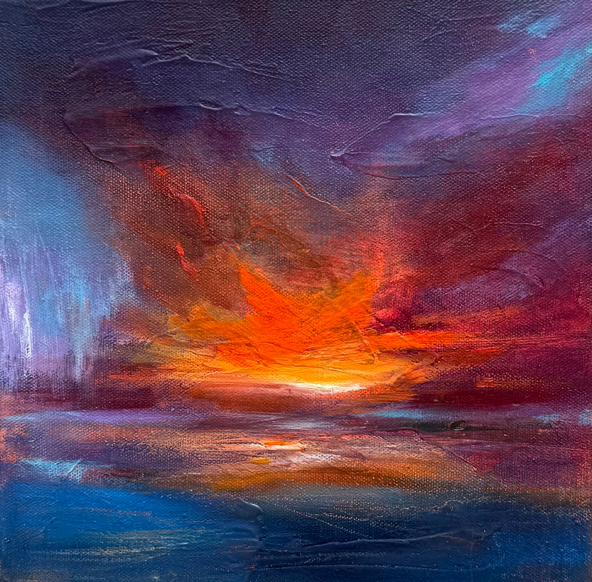 An abstract landscape painting of a dramatic sunset or sunrise over water, featuring a bright orange and yellow horizon surrounded by deep red, purple, and blue textured sky and water.